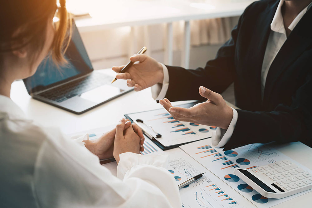 Advisor discussing plan of investment of financial report to client